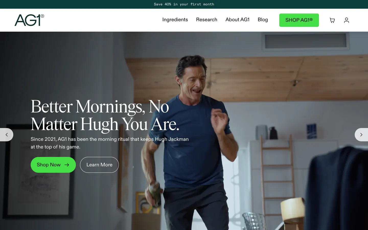 AG1 home page: Save 40% in your first month in the top bar, a campaign with Hugh Jackman, Shop Now
