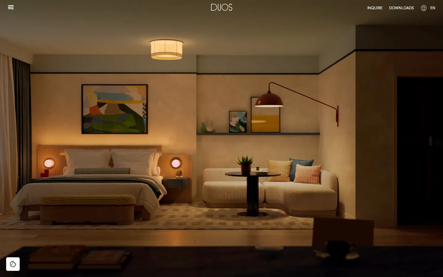 DUOS suites page: a furnished hotel suite with warm lamps and art on the wall